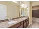Modern bathroom features a dual sink vanity, granite countertops, and decorative backsplash at 9737 Toad Hollow St, Las Vegas, NV 89141