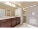Elegant bathroom with dual vanity, decorative mirror, and stand-up shower for a luxurious feel at 9737 Toad Hollow St, Las Vegas, NV 89141