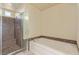 Well-lit bathroom with a shower and soaking tub, perfect for relaxation and convenience at 9737 Toad Hollow St, Las Vegas, NV 89141