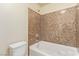 Bright bathroom showcases a soaking tub with tiled walls, providing relaxation and charm at 9737 Toad Hollow St, Las Vegas, NV 89141