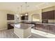 Modern kitchen featuring dark cabinets, granite countertops, and a large island at 9737 Toad Hollow St, Las Vegas, NV 89141