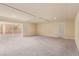 Spacious living room with plush carpeting and a sliding door for bright natural light at 9737 Toad Hollow St, Las Vegas, NV 89141