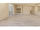 Open-concept living room featuring a built-in display and access to the patio via a sliding door at 9737 Toad Hollow St, Las Vegas, NV 89141