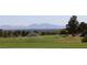 Expansive golf course with automatic sprinklers and mountain views in the background at 9904 Arbuckle Dr, Las Vegas, NV 89134