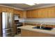 Kitchen with stainless steel appliances and wood cabinets and a central island at 9904 Arbuckle Dr, Las Vegas, NV 89134