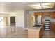 Open concept kitchen with stainless steel appliances and a center island with sink at 9904 Arbuckle Dr, Las Vegas, NV 89134