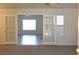 Bright living room with carpet and french doors leading to another living space with wood floors at 9904 Arbuckle Dr, Las Vegas, NV 89134