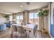 Bright dining room with a modern table, hardwood floors, and natural lighting from large windows at 10382 Luna Mezzo St Ave # Lot 196, Las Vegas, NV 89141