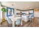 Modern kitchen with stainless steel appliances, an island with seating, and a dining area at 10382 Luna Mezzo St Ave # Lot 196, Las Vegas, NV 89141
