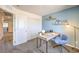 Bright office features a light wood desk and neutral walls with blue accent at 10382 Luna Mezzo St Ave # Lot 196, Las Vegas, NV 89141