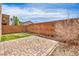 Back yard with a brick patio, artificial turf, and block wall for privacy at 10509 Hartford Hills Ave, Las Vegas, NV 89166