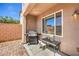 Covered outdoor patio area with BBQ, table and chairs, perfect for dining al fresco at 10509 Hartford Hills Ave, Las Vegas, NV 89166