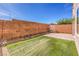 Low-maintenance backyard features artificial turf and a brick privacy wall, ideal for outdoor enjoyment at 10509 Hartford Hills Ave, Las Vegas, NV 89166