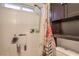 Bathroom featuring a shower, shower curtain, and storage shelving for toiletries and bathroom accessories at 10509 Hartford Hills Ave, Las Vegas, NV 89166
