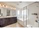 Bathroom with a soaking tub, shower, dual sinks, and a large vanity area with stylish lighting at 10509 Hartford Hills Ave, Las Vegas, NV 89166