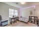 Cozy bedroom setup with a desk, bed, and shelf, creating a comfortable study and rest space at 10509 Hartford Hills Ave, Las Vegas, NV 89166