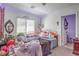 Comfortable bedroom featuring a window, with personal decorations creating a cozy and inviting space at 10509 Hartford Hills Ave, Las Vegas, NV 89166