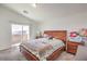 Spacious bedroom with a sliding glass door to the patio, complemented by a large bed and natural light at 10509 Hartford Hills Ave, Las Vegas, NV 89166