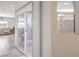Light-filled entryway with sliding glass doors and sidelight windows; tile flooring leads to stairs and living room at 10509 Hartford Hills Ave, Las Vegas, NV 89166