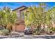 Charming stucco home with a two-car garage and front yard landscaping at 10509 Hartford Hills Ave, Las Vegas, NV 89166