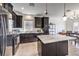 The kitchen features dark cabinetry, a center island with light countertops and stainless steel appliances at 10509 Hartford Hills Ave, Las Vegas, NV 89166