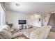 Cozy living room featuring tile floors, large windows, and staircase, creating a bright and welcoming space at 10509 Hartford Hills Ave, Las Vegas, NV 89166