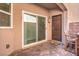 Outdoor patio featuring brick pavers, sliding glass door, and seating area, perfect for entertaining and relaxation at 10509 Hartford Hills Ave, Las Vegas, NV 89166
