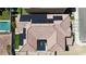 Aerial view of house with red tiled roof and solar panels, set within a desert landscape at 10729 Marathon Bell Ln, Las Vegas, NV 89129