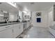 Elegant bathroom featuring a double vanity, tile floors, modern fixtures, and decor touches for a stylish look at 10729 Marathon Bell Ln, Las Vegas, NV 89129