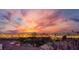 Sunset view of the Las Vegas strip skyline, with the roofline of community homes in foreground at 10729 Marathon Bell Ln, Las Vegas, NV 89129