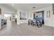Stylish dining room with modern light fixture, blue accent wall, and open layout connecting to kitchen at 10729 Marathon Bell Ln, Las Vegas, NV 89129