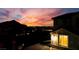 Dramatic sunset with house silhouette, showcasing a lit window, and mountain views in the background at 10729 Marathon Bell Ln, Las Vegas, NV 89129