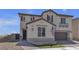 Inviting two-story home with desert landscaping, flag, and a stylish entrance creating curb appeal at 10729 Marathon Bell Ln, Las Vegas, NV 89129
