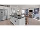 Bright, modern kitchen features stainless steel appliances, a large island with dark countertop, and an open floor plan at 10729 Marathon Bell Ln, Las Vegas, NV 89129