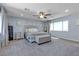 Spacious main bedroom with light blue walls, carpet, a ceiling fan, and lots of natural light at 10729 Marathon Bell Ln, Las Vegas, NV 89129