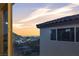 Scenic view from a window showcasing a tranquil neighborhood with a mountain backdrop at sunset at 10729 Marathon Bell Ln, Las Vegas, NV 89129