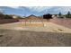 Large backyard featuring gravel, a planting bed, and a brick wall surround at 108 Spur Ranch Ave, North Las Vegas, NV 89032