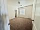Neutral bedroom with brown carpet, white walls, and bright natural light streaming through the window at 108 Spur Ranch Ave, North Las Vegas, NV 89032