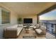 Staged balcony featuring modern seating, a TV, and views of the surrounding community at 1103 Tektite Ave, Henderson, NV 89011
