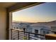 Expansive balcony view features rooftops in a modern neighborhood and mountains in the distance at 1103 Tektite Ave, Henderson, NV 89011