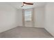 A bright, carpeted bedroom with a ceiling fan and a window with blinds and curtains at 1103 Tektite Ave, Henderson, NV 89011