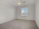 Bright bedroom featuring neutral carpet, white walls, and a window view to the outdoors at 1103 Tektite Ave, Henderson, NV 89011
