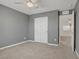 Spacious bedroom with gray walls, neutral carpet, a ceiling fan, and a closet at 1103 Tektite Ave, Henderson, NV 89011