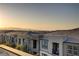 View of townhome community at sunset with mountain views in the distance at 1103 Tektite Ave, Henderson, NV 89011