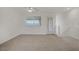 Bright living room featuring neutral carpet, white walls, and a ceiling fan for comfortable living at 1103 Tektite Ave, Henderson, NV 89011