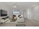 Spacious living room featuring a comfortable sofa, stylish decor, and ample natural light, virtually staged at 1103 Tektite Ave, Henderson, NV 89011