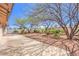 Backyard showcases a beautiful concrete patio, plants, and plenty of shade provided by mature landscaping at 133 Park Ridge Ln, Henderson, NV 89002