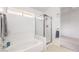 Bathroom featuring a separate tub, a glass enclosed shower, and tile surround at 133 Park Ridge Ln, Henderson, NV 89002