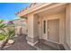 Inviting entryway featuring a covered porch and decorative plants, providing a warm welcome at 133 Park Ridge Ln, Henderson, NV 89002