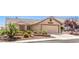 Charming single-story home boasts a two-car garage and well-manicured desert landscaping for enhanced curb appeal at 133 Park Ridge Ln, Henderson, NV 89002